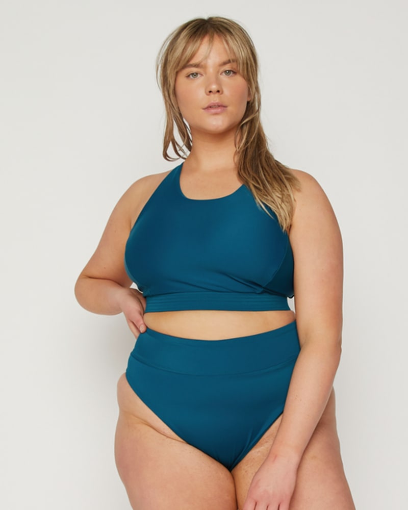 Front of a model wearing a size 3 Zoe High-Neck Bikini Top in Amalfi Blue by Wild Isles Swim. | dia_product_style_image_id:251754